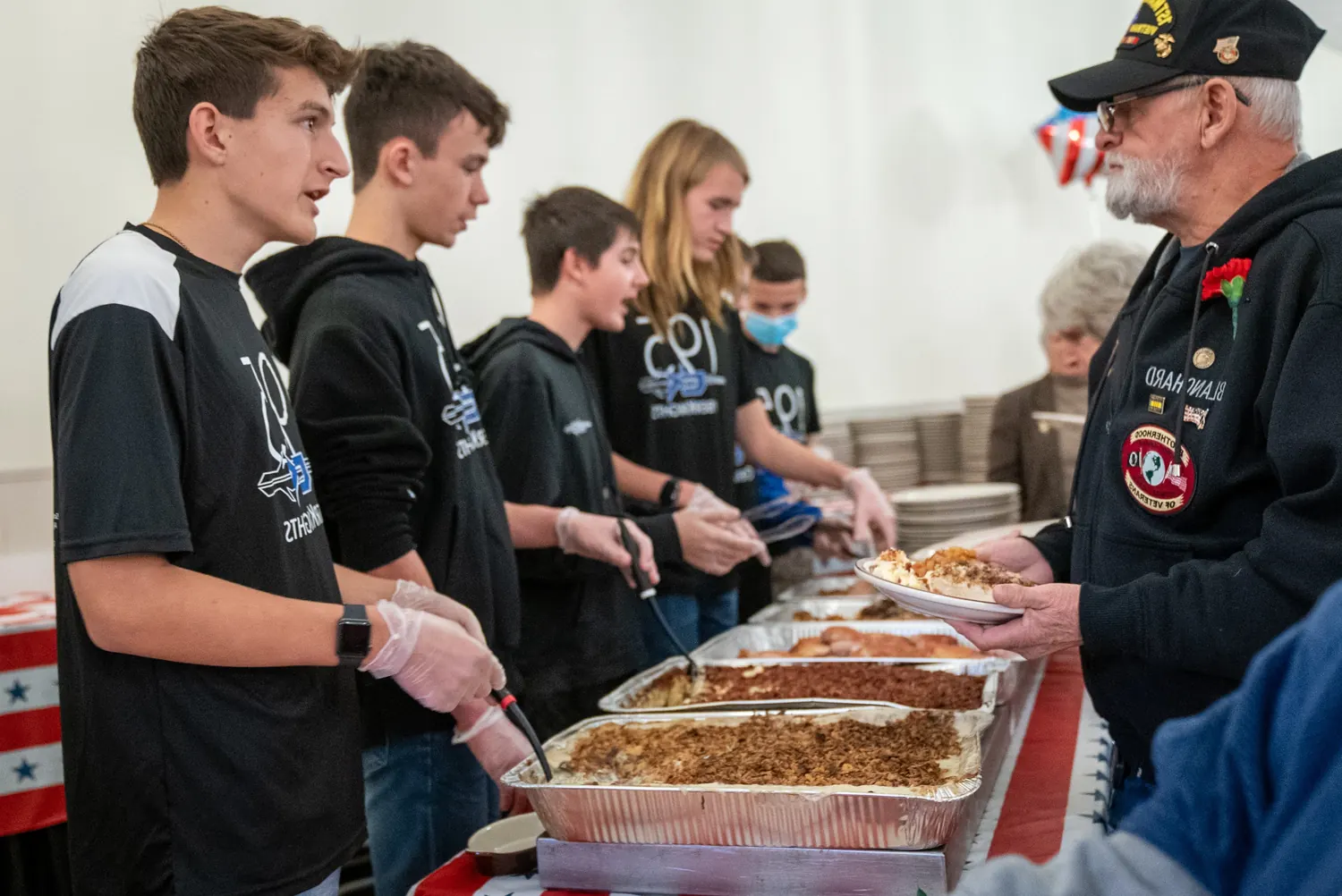 Team 195 students volunteering at the annual veterans dinner.